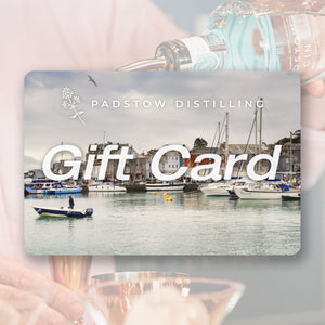An e-gift card from Padstow Distilling featuring an image of a Cornish harbor with boats and buildings in the background.