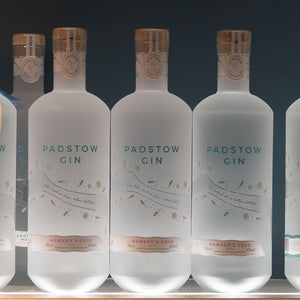 Row of Padstow Gin bottles with a dark background